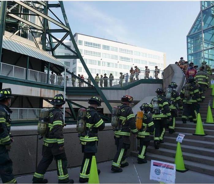 firefighters climbing stairs at event