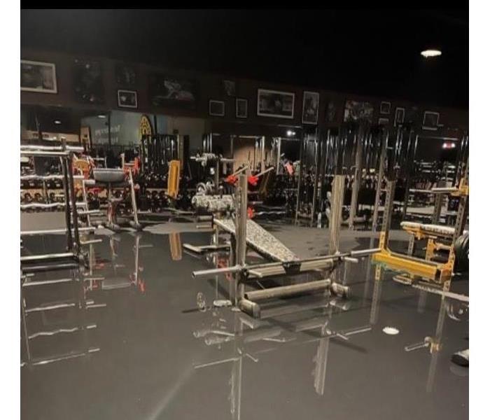 a gym with water damage on the floor