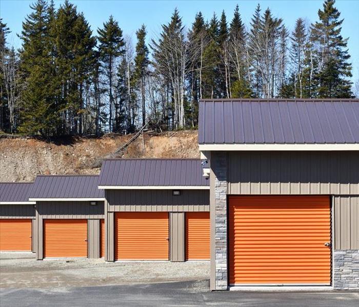 Four sets of storage units with orange doors. 