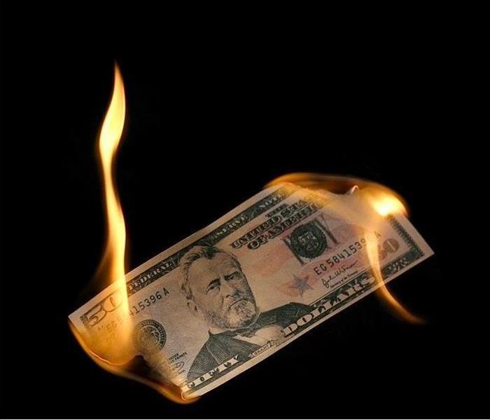 fifty-dollar bill burning on both ends